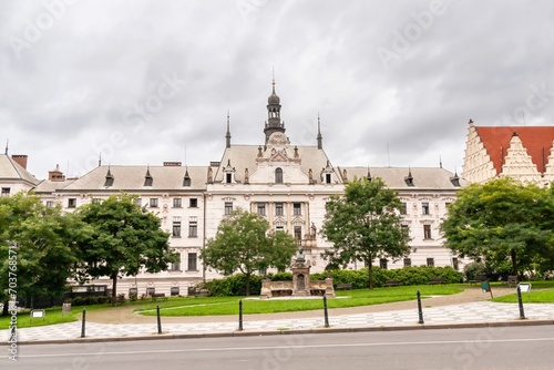 The historic architecture of Charles Square with a part of the New Town Hall (on the right) and Vítězslav Hálek Memorial (circa 1881), Prague photo