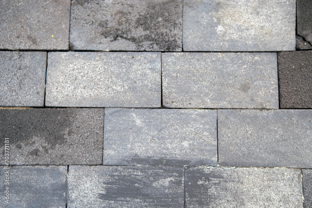 Fototapeta premium Weathered Grey Stone Pavement Texture: Irregular Rectangular Blocks