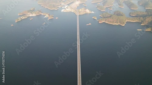 Aerial view of the beautiful landscape of Qiandaohu lake in Chunan, Hangzhou, Zhejiang, China. Thousands of tiny islands, straight Qiandaohu bridge over lake, 4k real time footage, drone view. photo