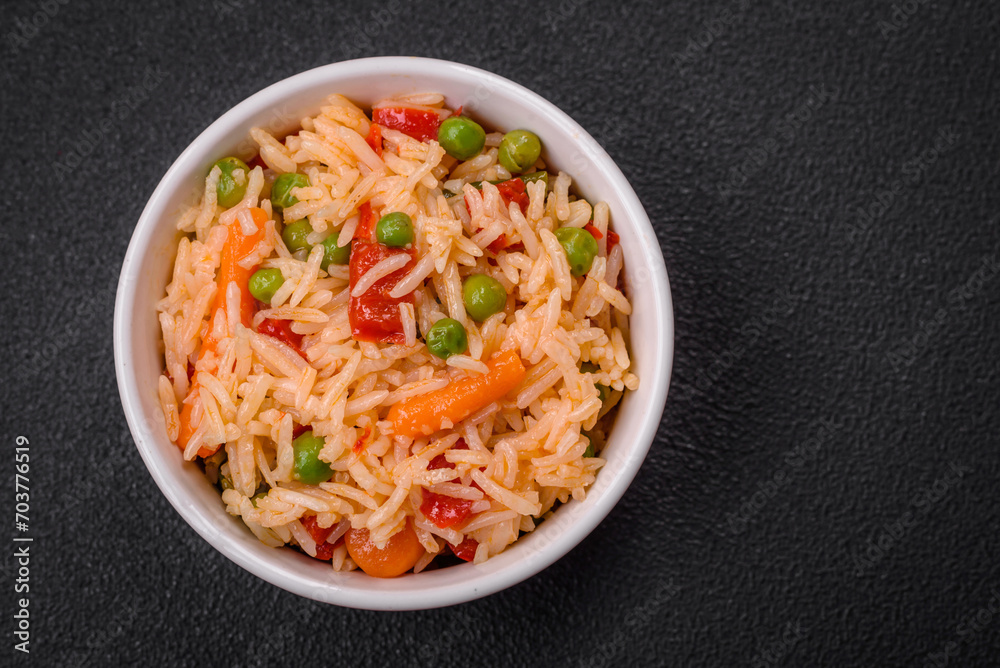 Delicious boiled rice with vegetables peppers, green peas, salt, spices and herbs Delicious boiled rice with vegetables peppers, green peas, salt, spices and herbs