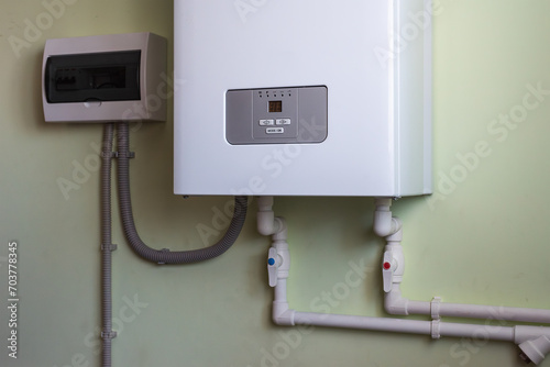 an electric boiler is installed on the wall with electric circuit breaker. heating of a private house.
