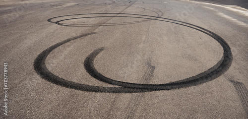 skid marks on a road surface. Circular tire marks left by drivers doing doughnuts photo