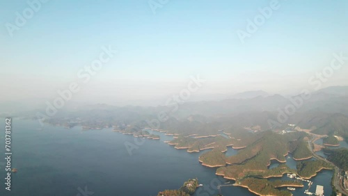 Aerial view of the beautiful landscape of Qiandaohu lake in Chunan, Hangzhou, Zhejiang, China. Blue lake water and blue sky, thousands of tiny islands in lake, 4k real time footage, drone view. photo