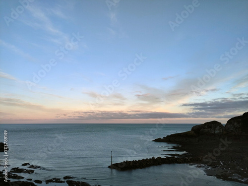 Pale sunrise. Combe Martin, North Devon