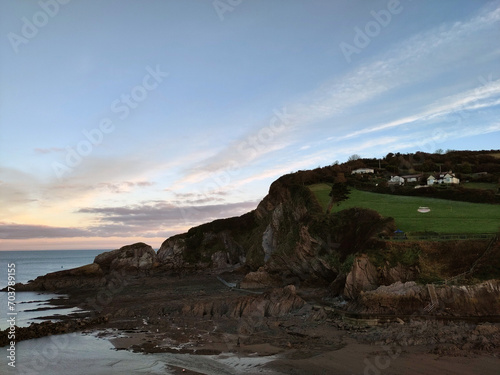 Pale sunrise. Combe Martin, North Devon