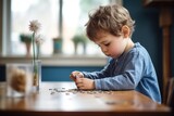 boy counting coins at a small wooden table