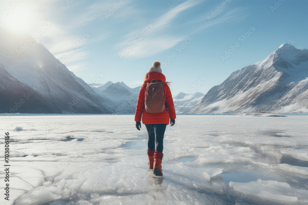 Mountain Escapade: Woman in Red Jacket Enjoying Frosty Lake Stroll