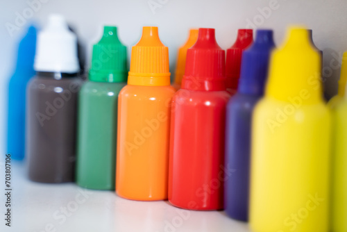 Bottles of art paints of various colors were lined up in large numbers