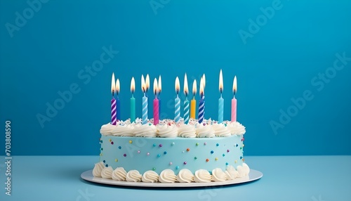 birthday cake with many birthday candles on a blue background photo