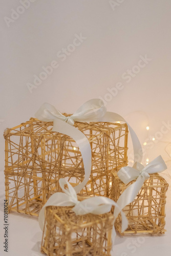 Wicker gift box with a white bow on a white fur background