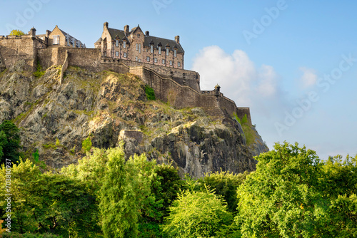 Edinburgh Castle  perched on its rock above the trees in Princes Street Gardens.