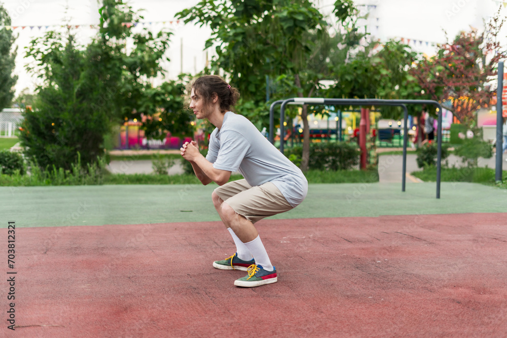 Early in the Morning: Squatting Man in a Serene Park Setting Early in the Morning: Squatting Man in a Serene Park Setting