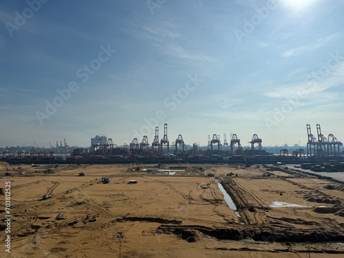 Port development at Colombo, Sri Lanka large construction site with dump trucks excavators and container terminals on the horizon