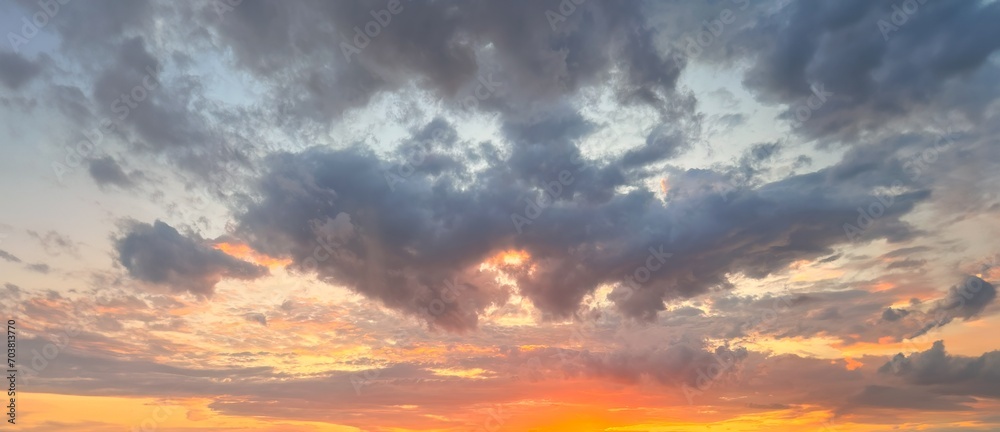 Obraz premium Natural sky background. A Symphony of Sunset Colors Painting the Evening Sky with Hues of Orange and Pink