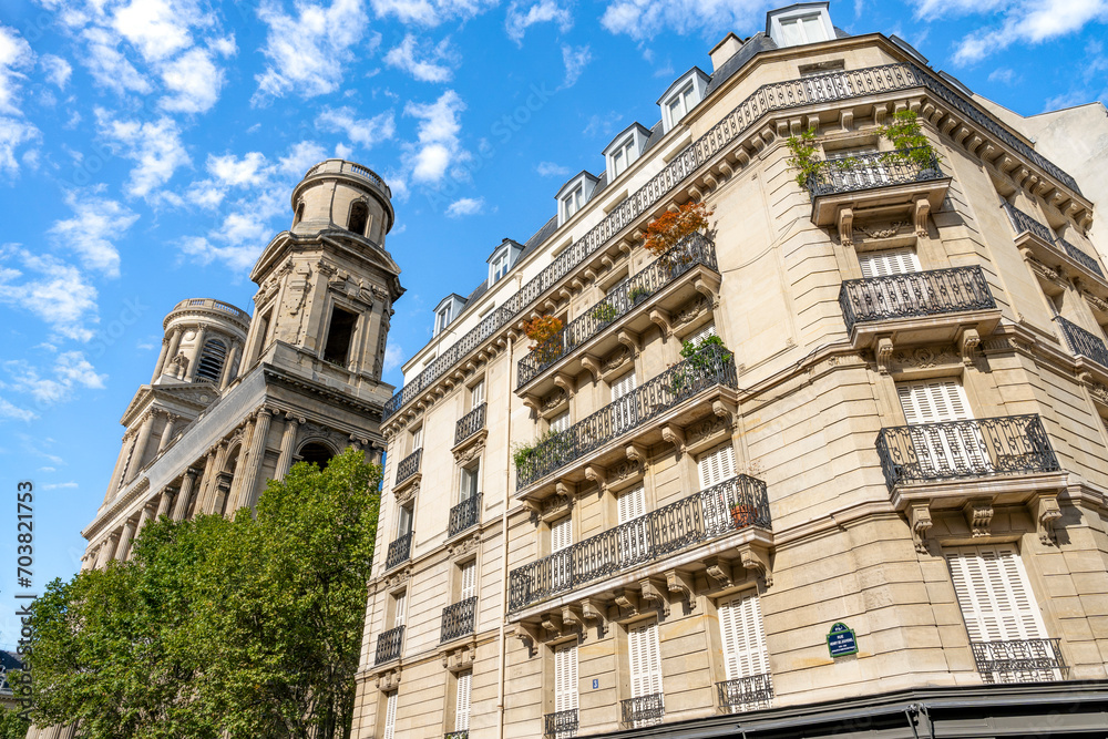 Glimpse of a typical and elegant residential building near place Saint Sulpice in Paris city center, France, with wrought iron railings and balconies  - obrazy, fototapety, plakaty 