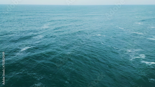 Panoramic aerial evening seascape calm ocean water waving. Gloomy marine scenery