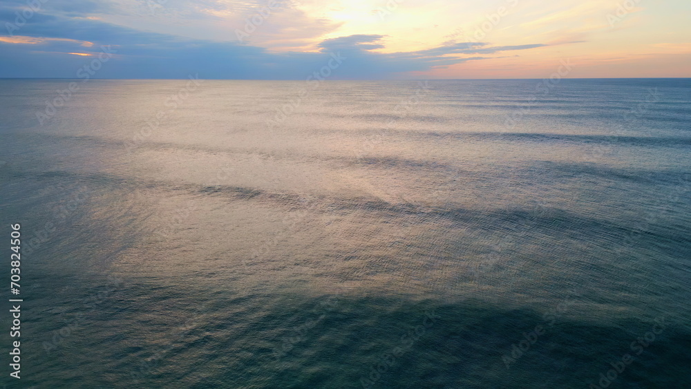 Beautiful cloudy ocean horizon at summer evening. Aerial stunning sea surface.