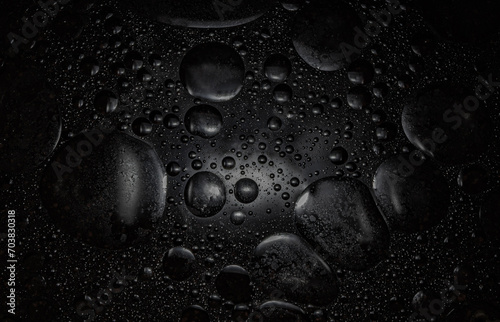  drops of oil on black background. Fantastic. Abstract.