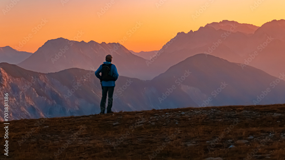 Alpine summer sunrise with a lonesome hiker at Mount Sechszeiger, Jerzens, Imst, Tyrol, Austria