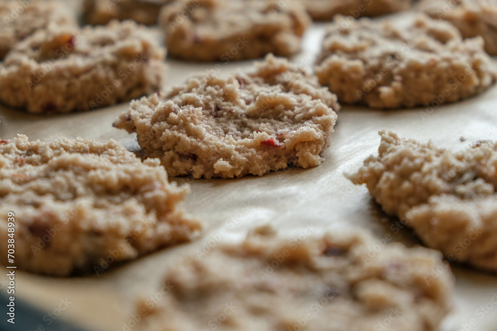 close up of fresh unbaked almond flour keto cookies lined on parchment paper ready to go in the oven close up of fresh unbaked almond flour keto cookies lined on parchment paper ready to go in the oven