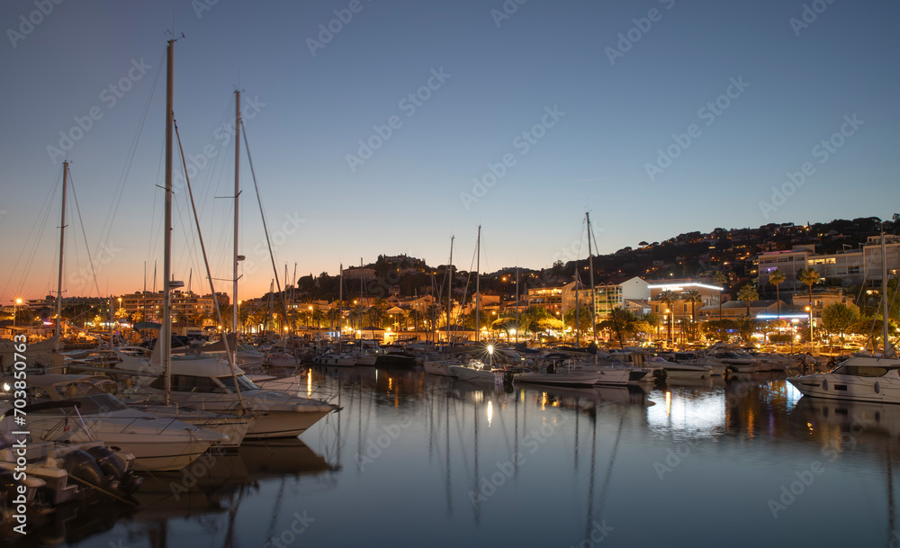 Port of Le Lavandou in the evening, France. Luxury yachts and motor boats.	
