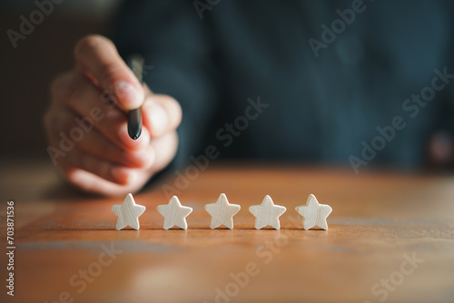 Customer Experience Concept. Man hand showing on five star excellent rating on background, copy space
