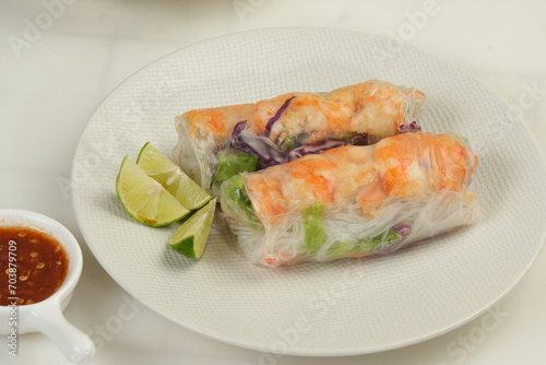 Fresh spring rolls with shrimp in rice paper. Rice paper rolls with shrimp, rice noodles,vegetable salad and sauce.