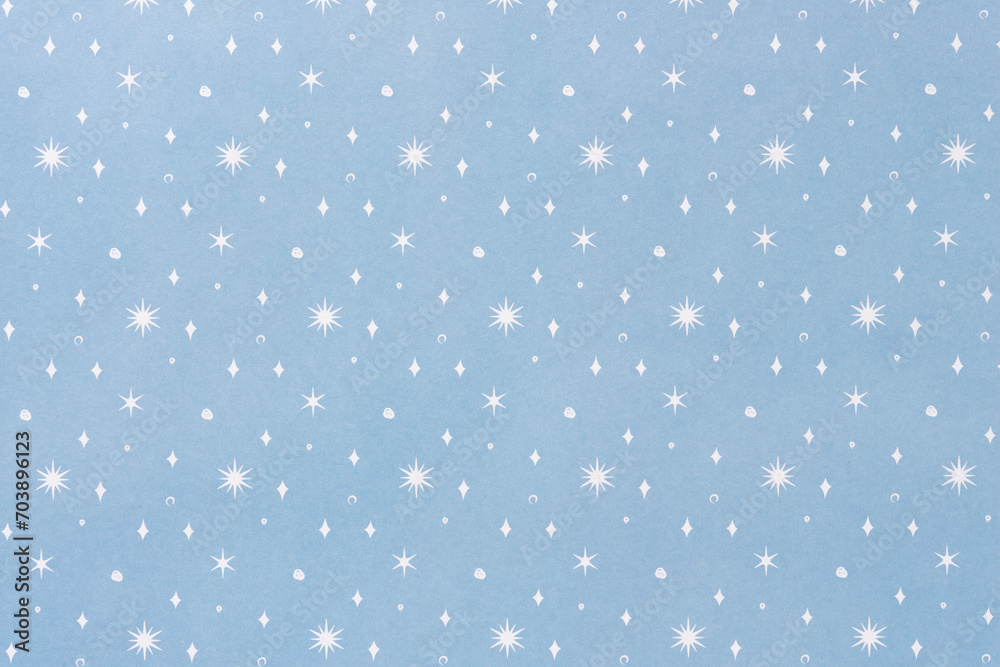 decorative holiday scrapbooking sheet background featuring white snow drops and flakes on blue