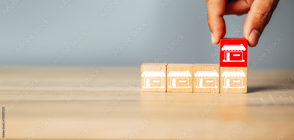 Cubes wood Franchise business,Businessman hand choose wooden blog with franchise marketing store icons.Franchise business concept. - obrazy, fototapety, plakaty 