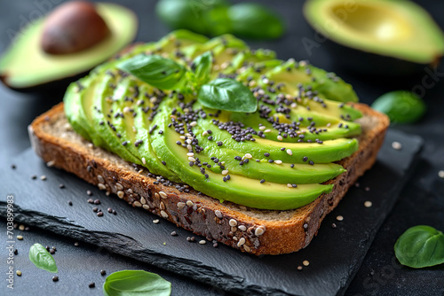 tasty whole grain bread with avocado slices and chia seeds for a healthy breakfast, close up