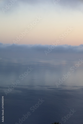 Misty morning with low clouds over the sea