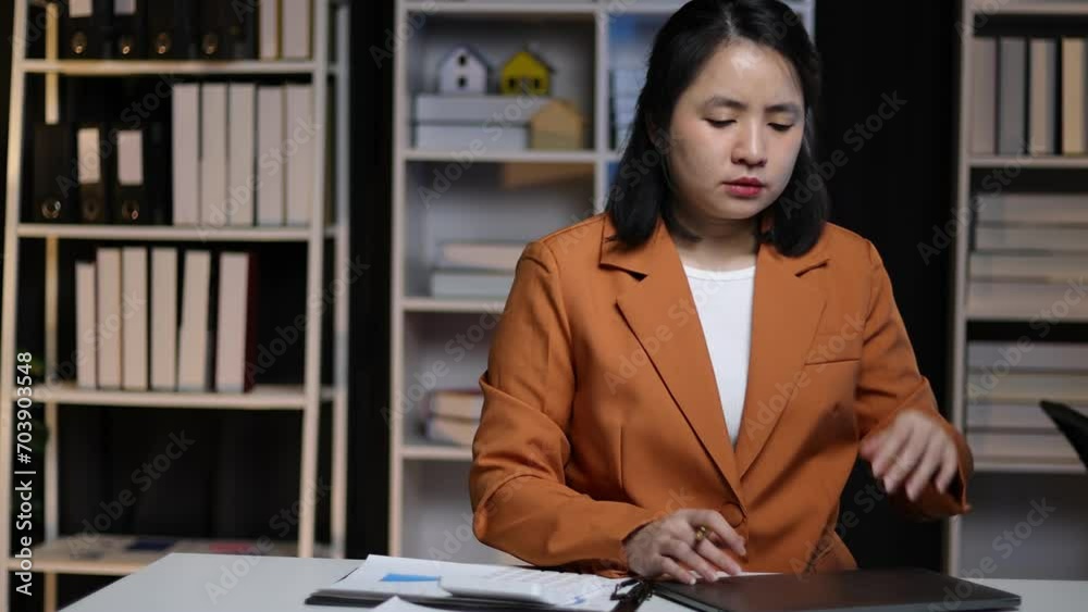 Serious businesswoman working overtime in the office are having stress from overworking and missing deadlines. Serious businesswoman working overtime in the office are having stress from overworking and missing deadlines.