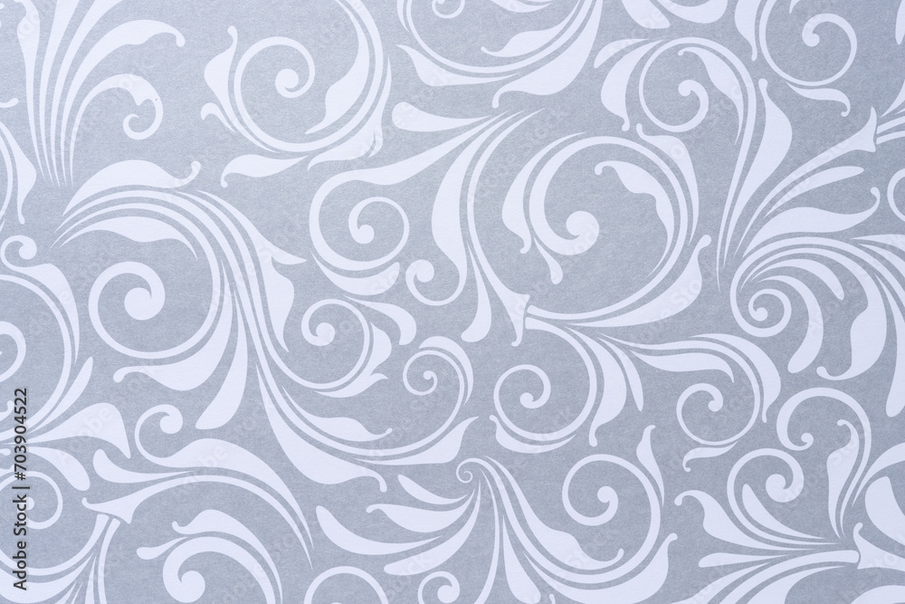 decorative scrapbooking sheet with floral patterns or swirls in silver gray