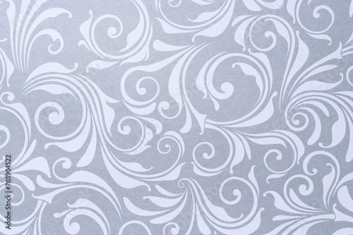 decorative scrapbooking sheet with floral patterns or swirls in silver gray