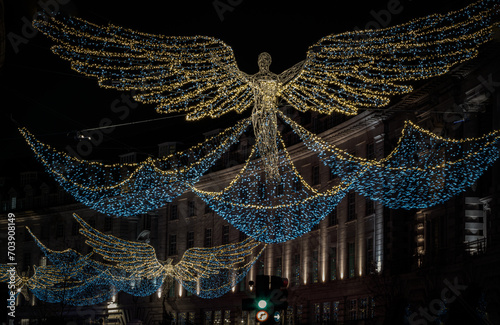 Flying angel Christmas decoration led lights display. Dramatic view of the traditional Christmas decoration lights hanging above Regent Street during dusk, The Spirit of Christmas, Light Festival.