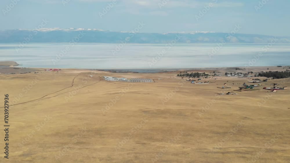 amazing landscape with large lake and mountains in horizon, touristic village on shore amazing landscape with large lake and mountains in horizon, touristic village on shore