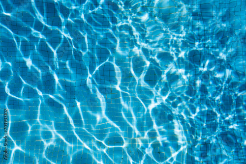 The texture of the water in the summer pool close-up.