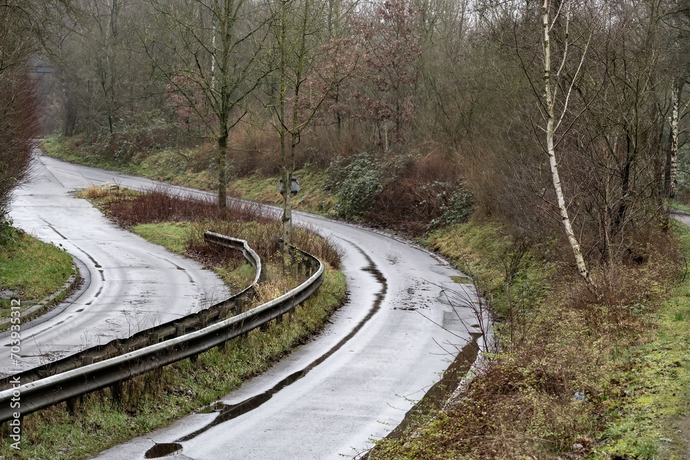 unused industrial road in poor condition in the rain