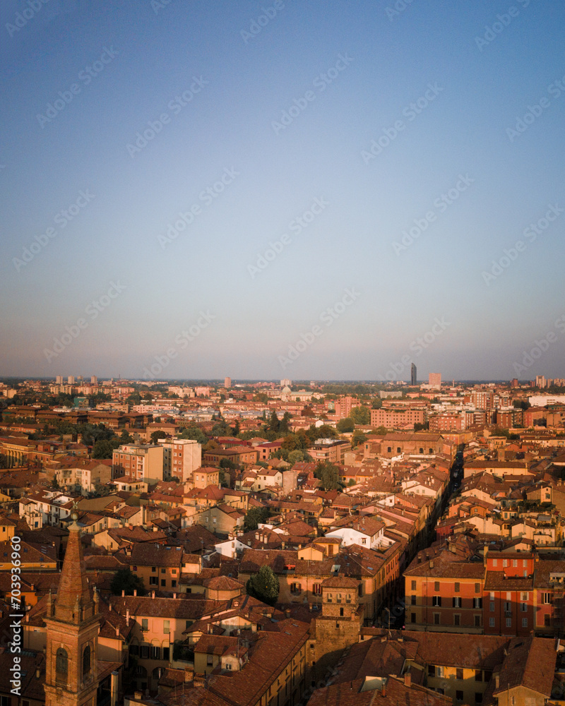 Bologna in the morning light from above, view from the sky, city landscape panoramic low sun view, Italian architecture from drone