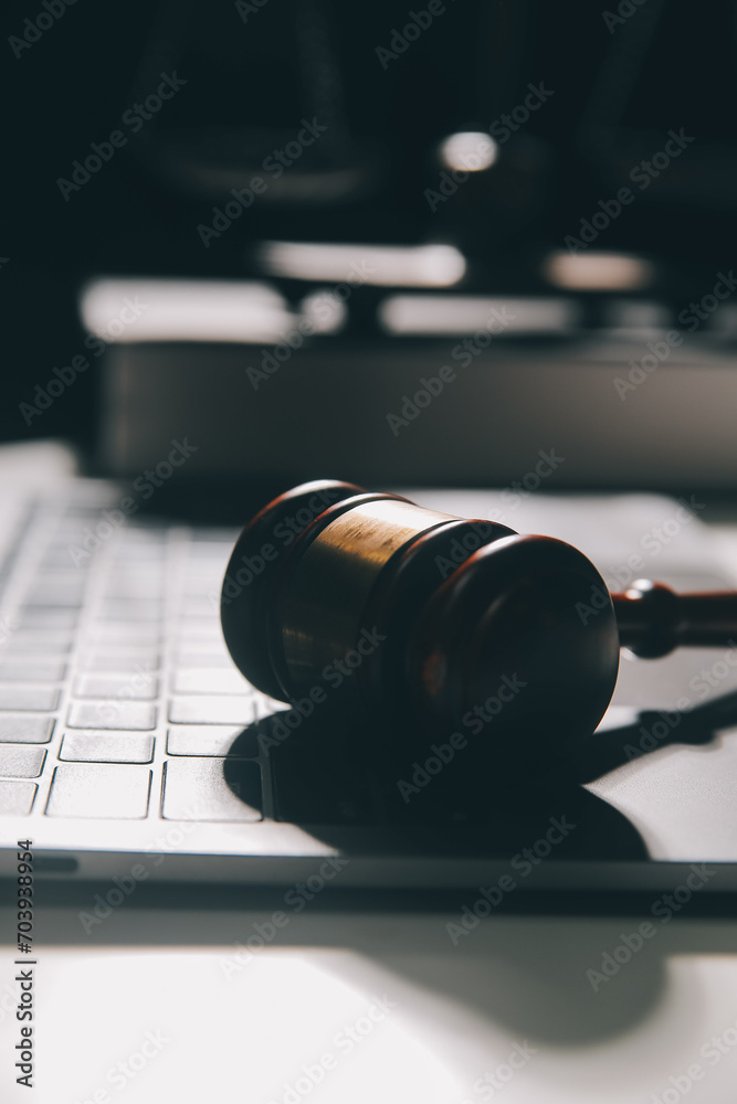 image of judge's hammer, scales lady of justice, law book, laptop computer and contract documents with pen concept of law and justice. image of judge's hammer, scales lady of justice, law book, laptop computer and contract documents with pen concept of law and justice.