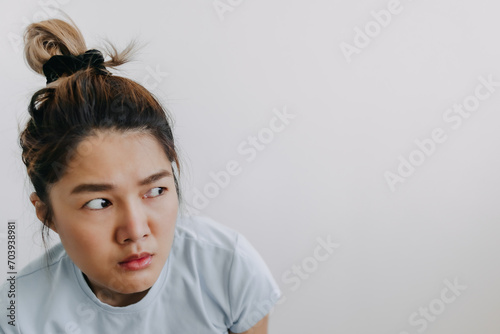 Funny face of asian Thai woman looking something at empty space with doubt and curious isolated over white background wall. photo