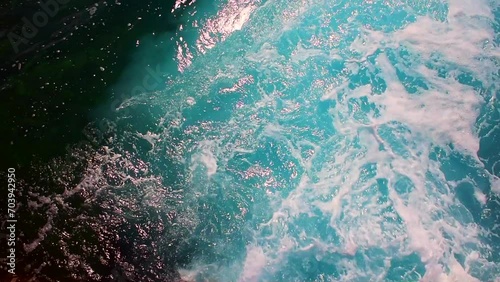 Beautiful turquoise sea waves lapping below with a lot of foam.