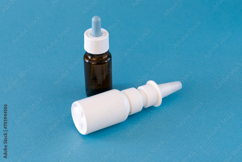 Medicine bottle with nasal drops on blue background Medicine bottle with nasal drops on blue background
