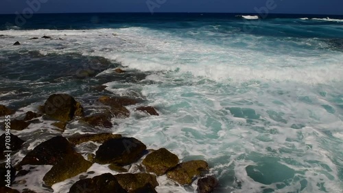 Beautiful turquoise sea waves lapping below with a lot of foam.