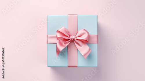 Blue gift box with shiny pink satin ribbon bow on pink background, Valentines day and Mothers day present concept. © Sunday Cat Studio