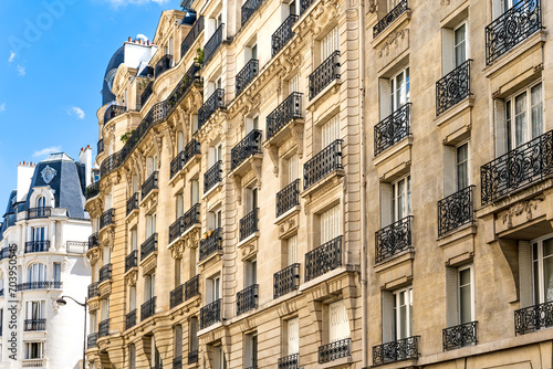 Glimpse of a typical and elegant residential building in Paris city center, France, with wrought iron railings and balconies 