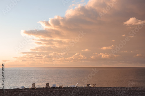 Shenzongs on the sea coast in weight. Beautiful sky with clouds.