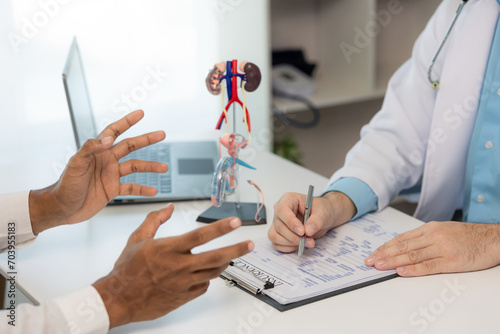 Close-up during consultation of a male patient suspected of having bacterial prostatitis. Prostate disease and treatment Anatomical model of the male reproductive system in the hands of a doctor.