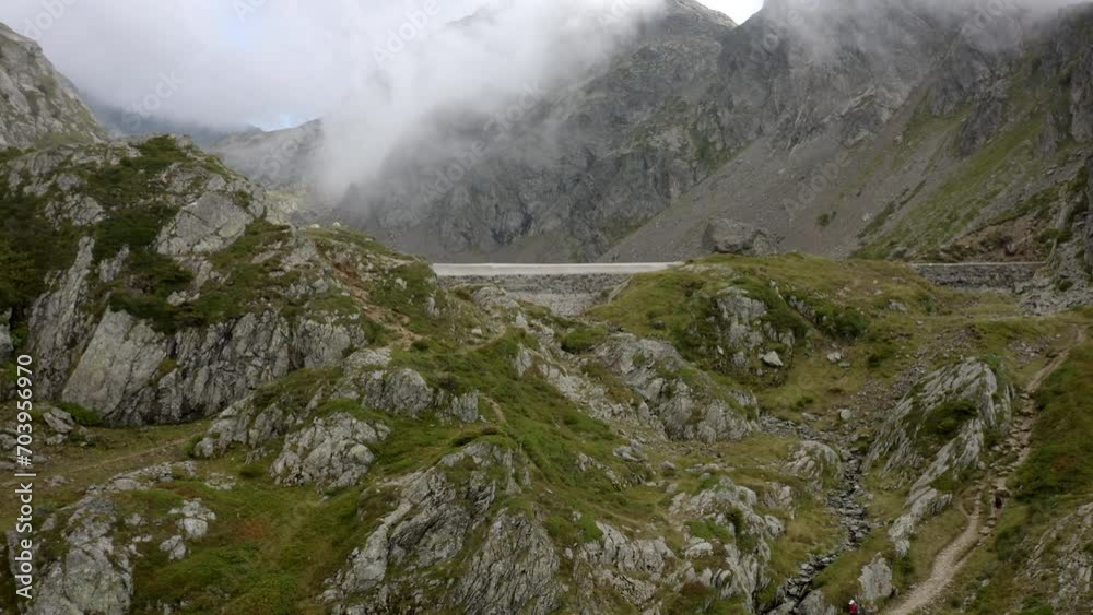 Aerial Backward Shot Of People Exploring Semi Arid Mountains During Vacation - French Alps, France Aerial Backward Shot Of People Exploring Semi Arid Mountains During Vacation - French Alps, France