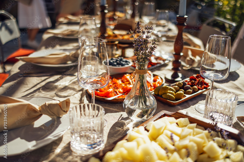 hairs and a table for guests, decorated with candles, are served with cutlery and crockery hairs and a table for guests, decorated with candles, are served with cutlery and crockery